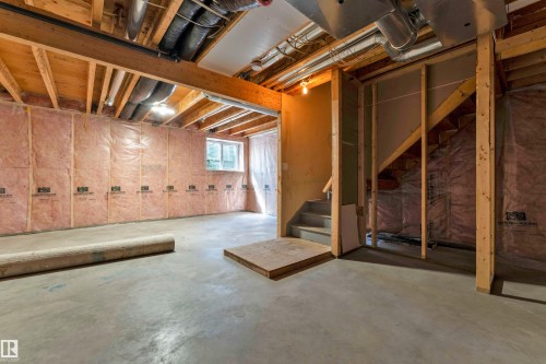 Unfinished basement featuring exposed wood joists and concrete flooring - 64 14208 36 Street, Edmonton, AB 