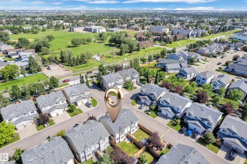 Aerial overview of a residential neighborhood with detached homes and townhouses - 64 14208 36 Street, Edmonton, AB 