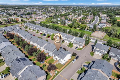 Aerial perspective of a residential neighborhood featuring rows of townhomes and detached properties - 64 14208 36 Street, Edmonton, AB 