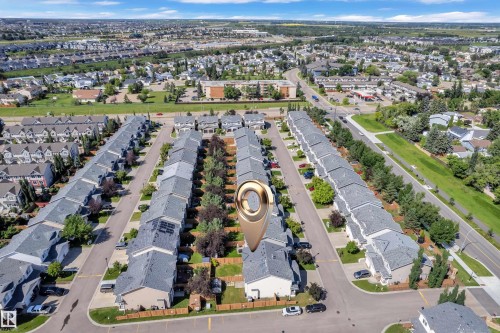 Aerial perspective of a developed residential area featuring rows of townhomes and detached properties - 64 14208 36 Street, Edmonton, AB 