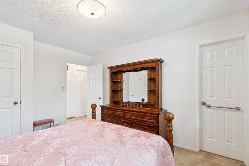 White walls complement light beige carpet flooring - 9315 168 Avenue Nw, Edmonton, AB 