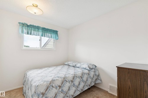 Compact room featuring a white-framed window, neutral wall paint, and a built-in overhead light fixture - 9315 168 Avenue Nw, Edmonton, AB 