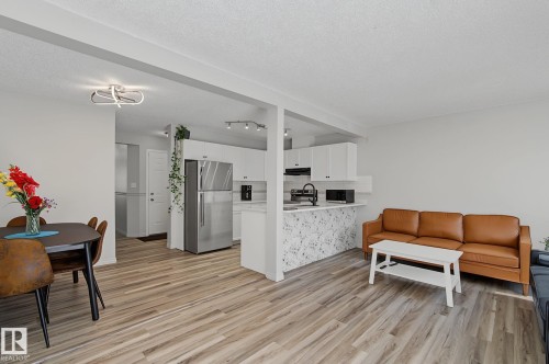 Open concept living area featuring wood-finish flooring - 5 14603 Miller Boulevard, Edmonton, AB 