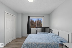 Bedroom featuring light gray walls and wood-finish flooring - 