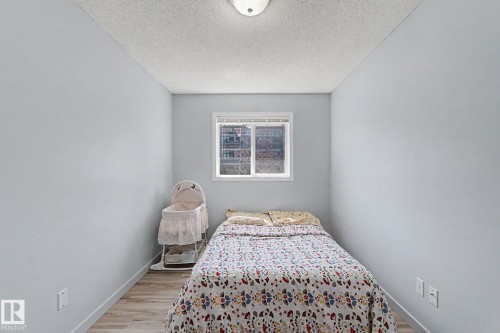 Compact room featuring light blue walls and wood-finish flooring - 5 14603 Miller Boulevard, Edmonton, AB 