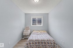 Compact room featuring light blue walls and wood-finish flooring - 