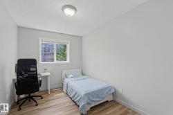 Room featuring a single window, overhead flush-mount lighting, light wood-finish flooring, and neutral wall paint - 