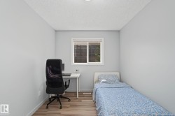 Bright room with light gray walls and wood-finish flooring - 