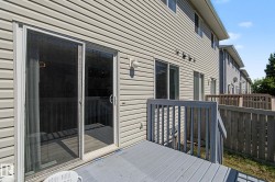 Outdoor deck featuring gray painted wood flooring and railing - 