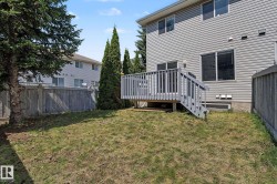Private backyard featuring a wooden deck with railing, stairs, and access to the home - 