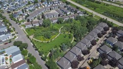 Residential neighborhood featuring a central green space with walking paths - 