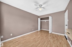 Room featuring wood-finish flooring, neutral wall paint, and a textured white ceiling - 