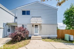 Two-story townhouse with light blue siding and a concrete foundation - 