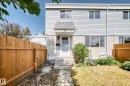 Two-story townhouse exterior with light-colored siding and a concrete foundation - 32 Mcleod Place, Edmonton, AB 