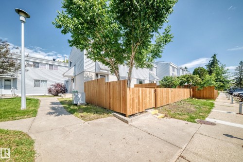 Newly installed wood fencing encloses a private yard space - 32 Mcleod Place, Edmonton, AB 