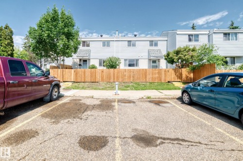 Paved parking lot with designated spaces directly fronting residential units - 32 Mcleod Place, Edmonton, AB 