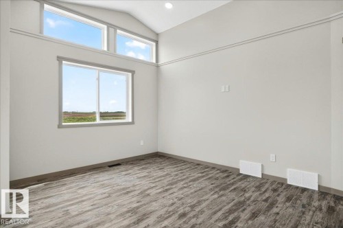 Vaulted ceilings with recessed lighting and a wood-finish floor - 1 Whitetail Way, Mundare, AB 