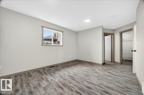 Room featuring wood-finish flooring, light gray wall paint, and white ceilings - 1 Whitetail Way, Mundare, AB 
