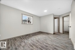 Room featuring wood-finish flooring, light gray wall paint, and white ceilings - 