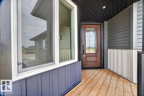 Covered entry porch featuring wood-finish decking - 1 Whitetail Way, Mundare, AB 