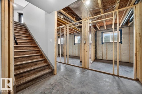 Lower level featuring wood-finish stairs with a dark handrail - 1 Whitetail Way, Mundare, AB 