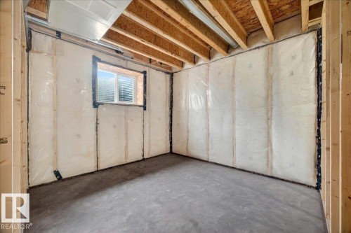Unfinished basement with concrete flooring and exposed wood framing - 1 Whitetail Way, Mundare, AB 