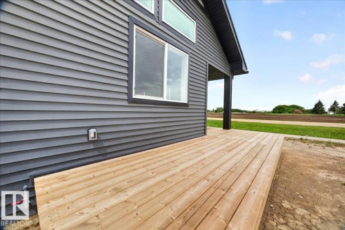 Expansive exterior deck crafted from natural wood planks - 1 Whitetail Way, Mundare, AB 