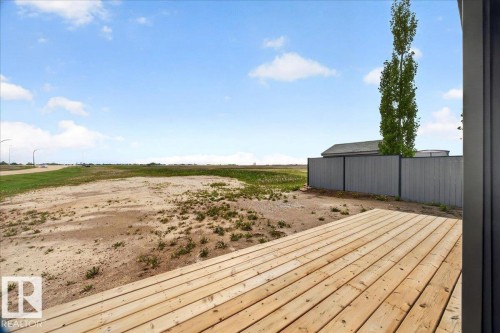 Spacious rear deck featuring natural wood planks - 1 Whitetail Way, Mundare, AB 