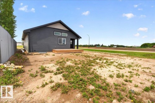 Contemporary dark gray siding exterior with a light wood accent gable - 1 Whitetail Way, Mundare, AB 