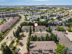 Aerial perspective showcasing a residential neighborhood with a distant cityscape - 