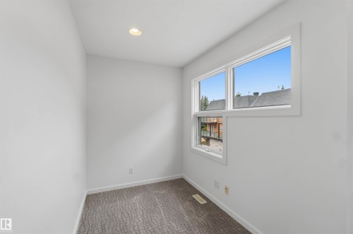 White walls with a window featuring white trim - 1 14315 Stony Plain, Edmonton, AB 