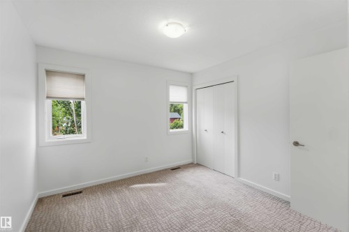 Neutral-toned carpeting complements white wall finishes - 1 14315 Stony Plain, Edmonton, AB 