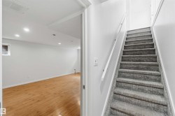 Carpeted staircase with white wall-mounted handrail - 