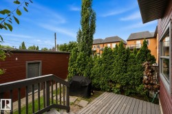 Outdoor deck featuring wood-finish boards and dark-stained railings - 