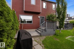 Red-sided exterior with a multi-level deck and a partial lawn area - 