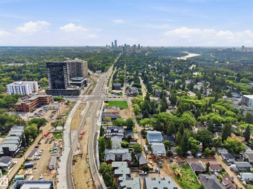 Expansive urban landscape featuring a distant city skyline, a prominent river, and a mix of residential and commercial structures - 1 14315 Stony Plain, Edmonton, AB 