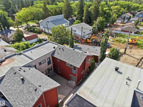 Multi-level property featuring red siding and a composition shingle roof - 1 14315 Stony Plain, Edmonton, AB 