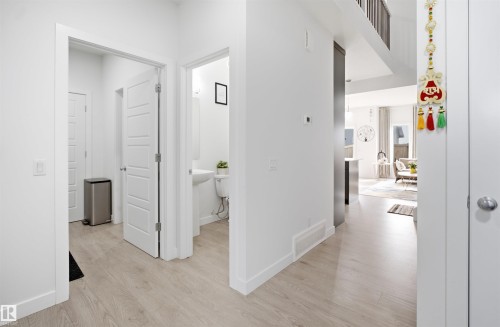 Bright hallway featuring light wood-finish flooring and crisp white walls - 2508 193 Street, Edmonton, AB 