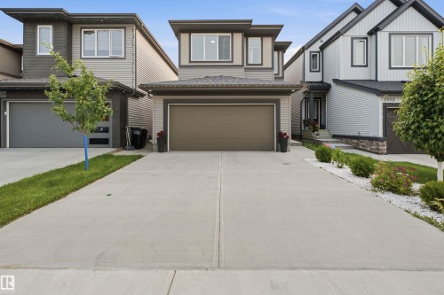Contemporary two-story residence featuring a neutral siding facade with dark trim accents - 2508 193 Street, Edmonton, AB 