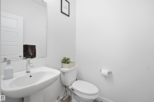 Pedestal sink with chrome faucet, complemented by a wall-mounted mirror - 2508 193 Street, Edmonton, AB 