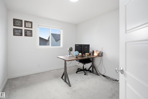 Light gray carpet flooring, white walls, and a large window with white trim - 2508 193 Street, Edmonton, AB 