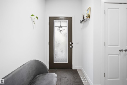 Entryway featuring a dark-framed door with frosted glass, white interior walls, and light-toned flooring - 2508 193 Street, Edmonton, AB 
