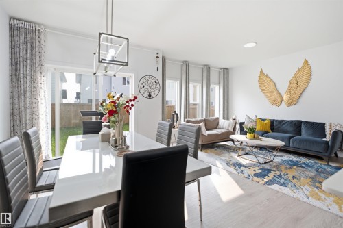 Open-concept living and dining area featuring light wood-finish flooring - 2508 193 Street, Edmonton, AB 