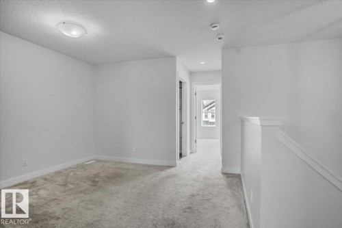 Upper-level landing featuring neutral carpeting, white trim, and recessed lighting - 2852 Duke Crescent, Edmonton, AB 