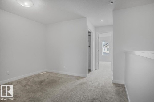 Carpeted room featuring white painted walls and baseboards - 2852 Duke Crescent, Edmonton, AB 