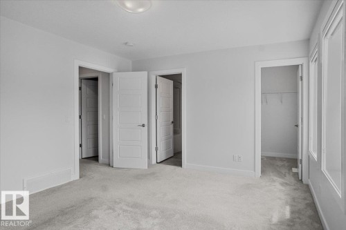 Carpeted room with light grey walls and white trim - 2852 Duke Crescent, Edmonton, AB 