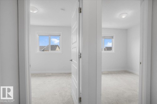 Two separate rooms featuring light gray carpeting and white walls - 2852 Duke Crescent, Edmonton, AB 