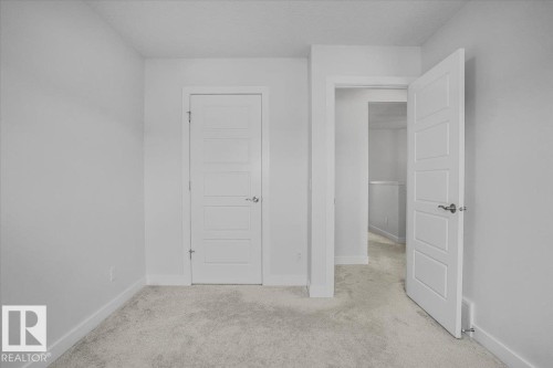 Neutral-toned carpeting and white painted walls define this interior space - 2852 Duke Crescent, Edmonton, AB 