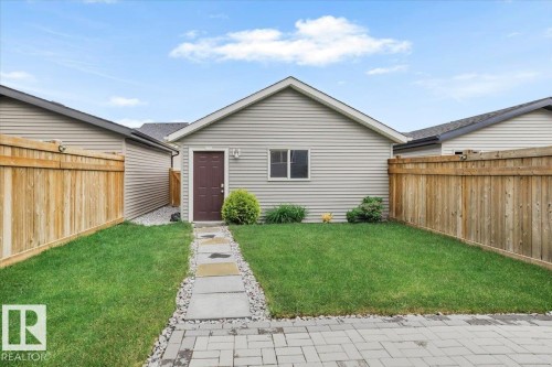 Detached auxiliary structure featuring horizontal siding, a gabled roofline, and a single entry door - 2852 Duke Crescent, Edmonton, AB 