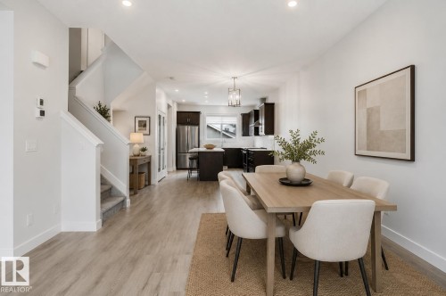 Open-concept dining area featuring wood-finish flooring and recessed lighting - 2852 Duke Crescent, Edmonton, AB 